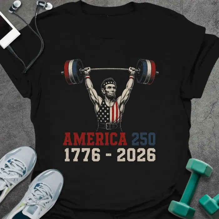Black t-shirt with Abraham Lincoln lifting dumbbells graphic in white and gold