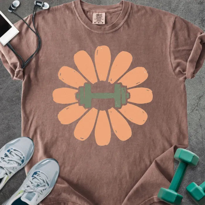 Espresso t-shirt with coral/peach flower and dumbbell in center in peach and green