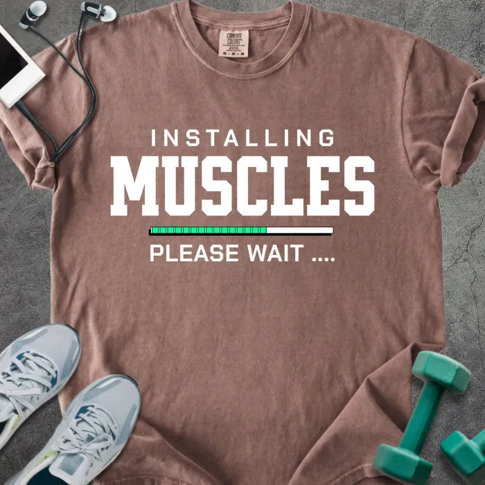 Espresso t-shirt printed with "Installing Muscles Please Wait ...." in white and multicolor, with a loading bar