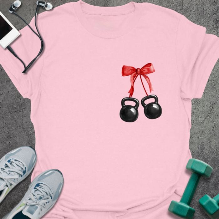 Light pink t-shirt with two kettlebells tied with a red ribbon in red, white