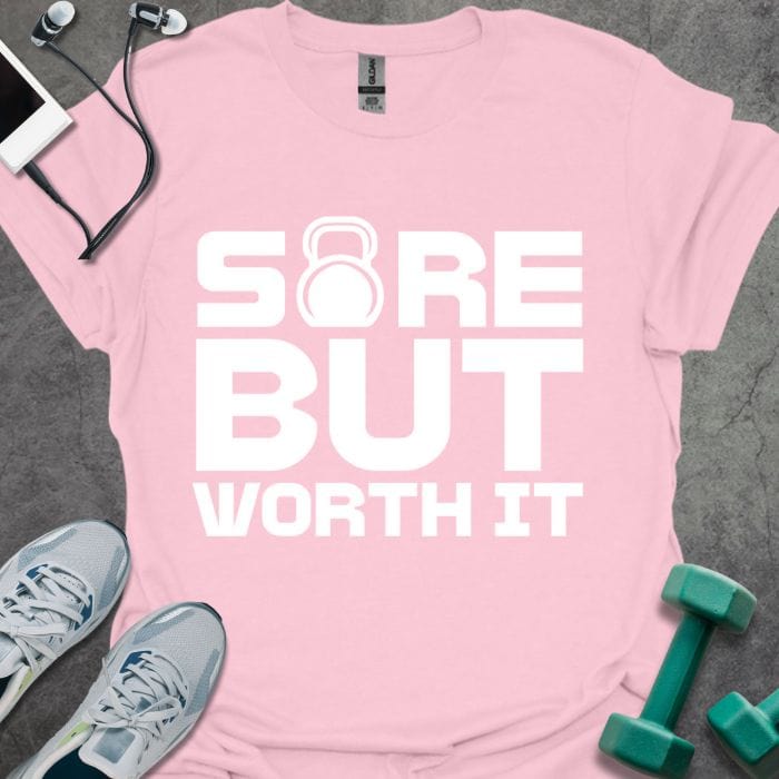 Light pink t-shirt printed with "Sore but Worth it", with kettlebell icon