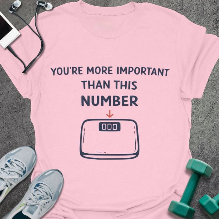 Light pink t-shirt printed with "You're More Important Than This Number", with scale illustration