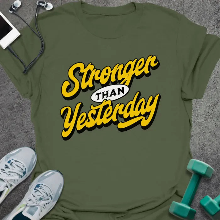 Military green t-shirt printed with "Stronger THAN Yesterday" in yellow
