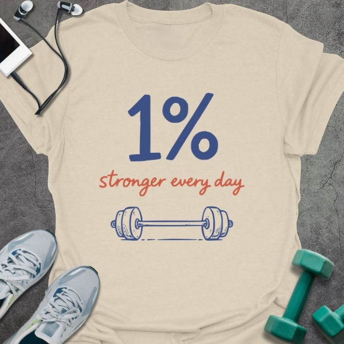 Cream t-shirt printed with "1% stronger every day" in blue and red, with dumbbell illustration
