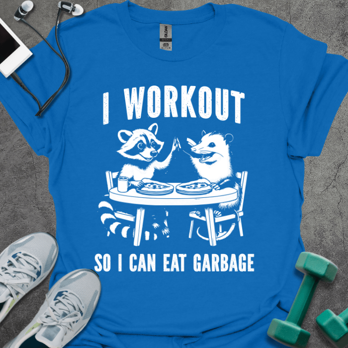 Royal blue t-shirt printed with "I Workout so I Can Eat Garbage", with two cartoon animals dining at a table