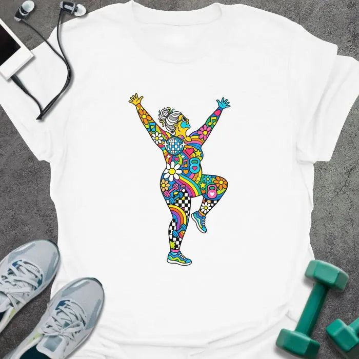 White t-shirt printed with an older woman with a gray bun dancing with her arms up, her body filled with colorful flowers, rainbows, hearts, music notes and a disco ball