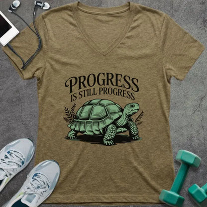 Tan v-neck showing turtle with "PROGRESS IS STILL PROGRESS" text