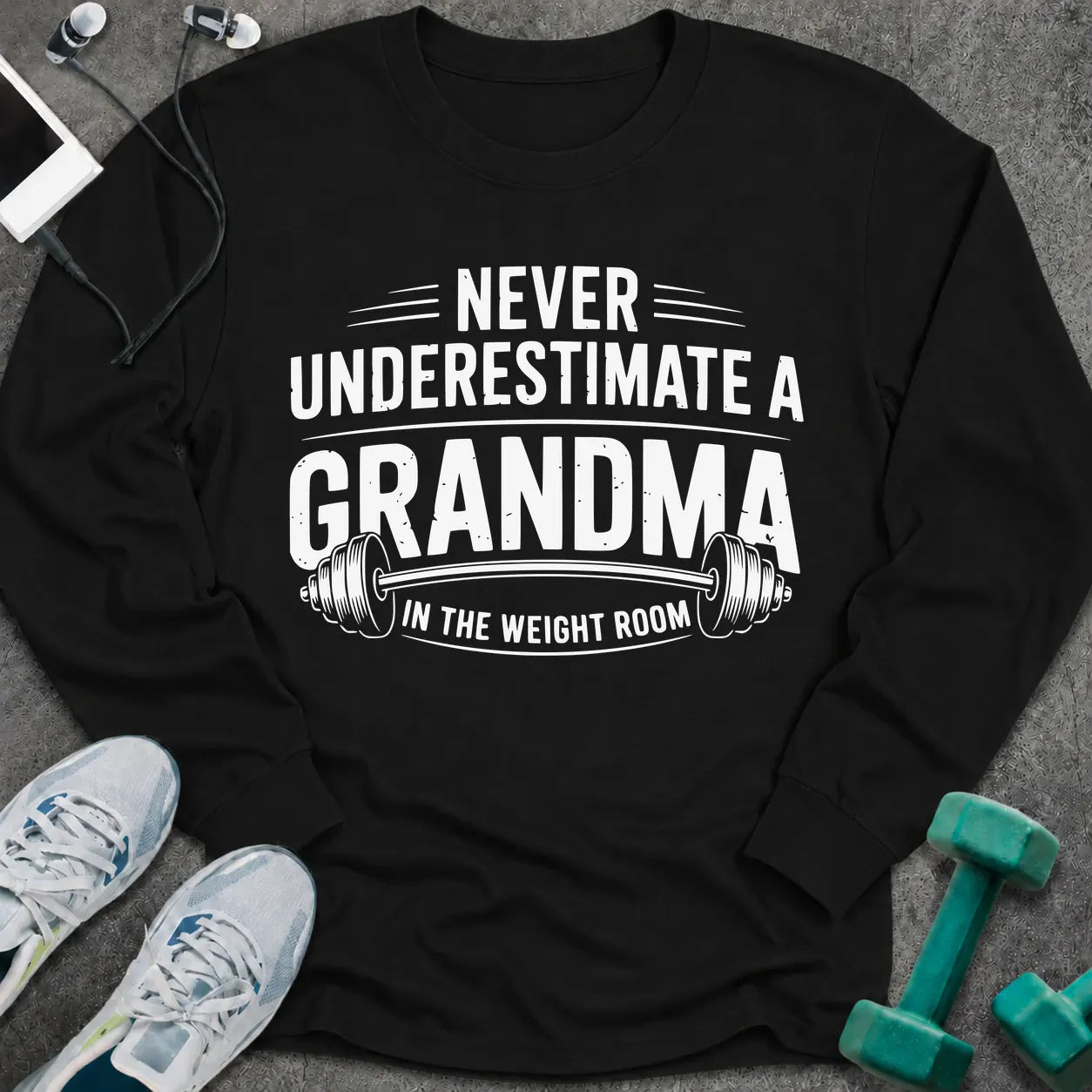 Black long sleeve tee printed with "Never Underestimate A Grandma In The Weight Room" in white, with a barbell