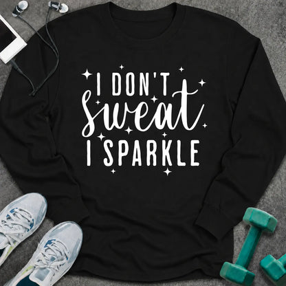 Black long sleeve tee printed with "I Don't Sweat I Sparkle" in white script, with sparkle stars