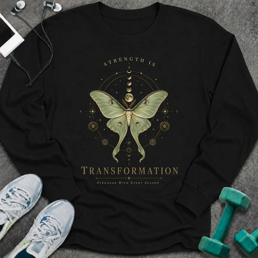 Black long sleeve tee printed with "Strength Is Transformation" in gold, with a luna moth beneath a row of moon phases