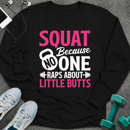 Black long sleeve tee printed with "Squat Because No One Raps About Little Butts" in pink and white, with a kettlebell and dumbbells worked into the lettering