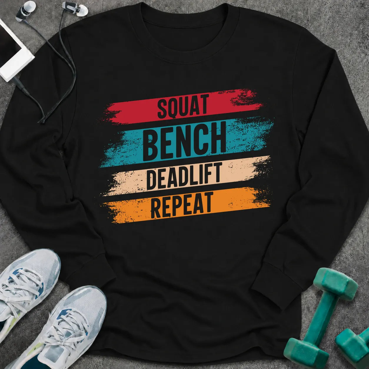Black long sleeve tee printed with "Squat Bench Deadlift Repeat" in white, with teal, cream and orange brush strokes behind each word