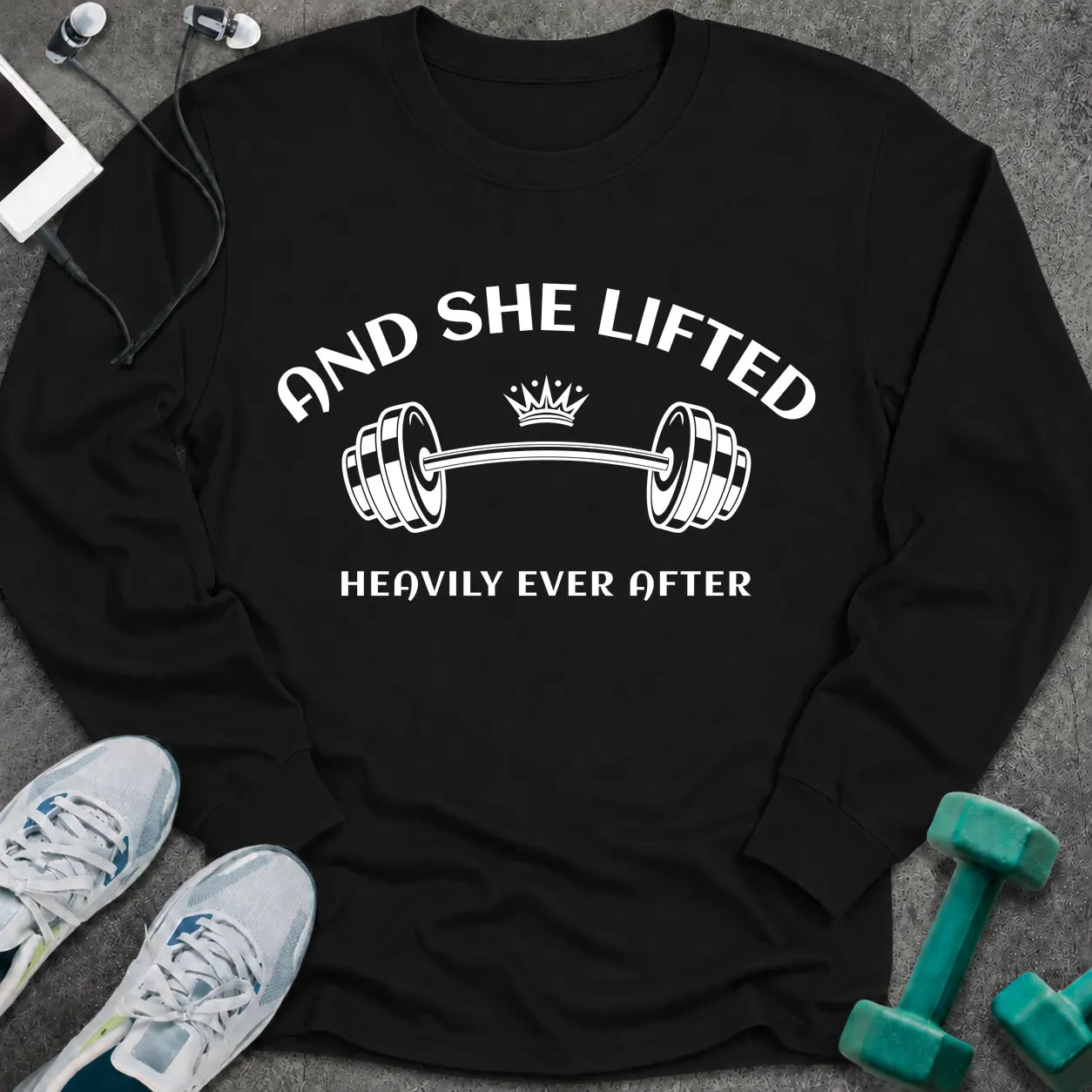 Black long sleeve tee printed with "And She Lifted Heavily Ever After" in white, with a barbell topped with a crown