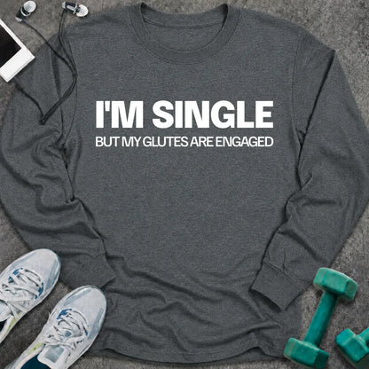 Dark heather long sleeve tee printed with "I'm Single But My Glutes Are Engaged" in white