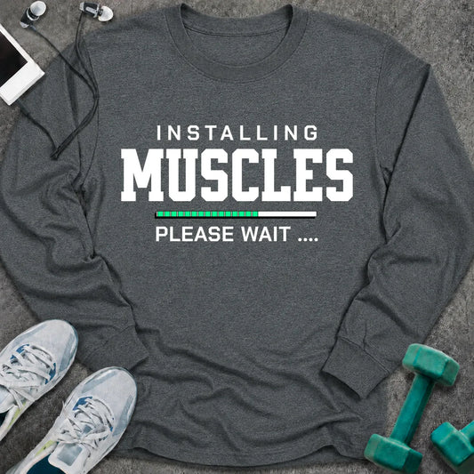 Dark heather long sleeve tee printed with "Installing Muscles Please Wait" in white, with a green loading bar