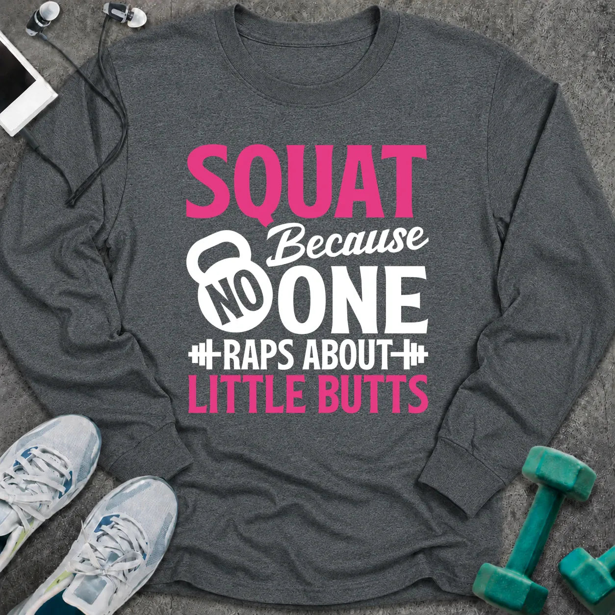 Dark heather long sleeve tee printed with "Squat Because No One Raps About Little Butts" in pink and white, with a kettlebell and dumbbells worked into the lettering
