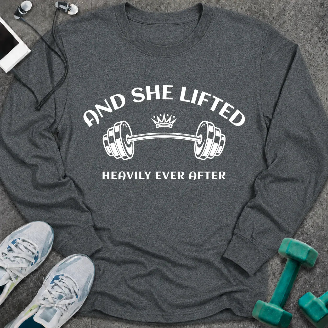 Dark heather long sleeve tee printed with "And She Lifted Heavily Ever After" in white, with a barbell topped with a crown