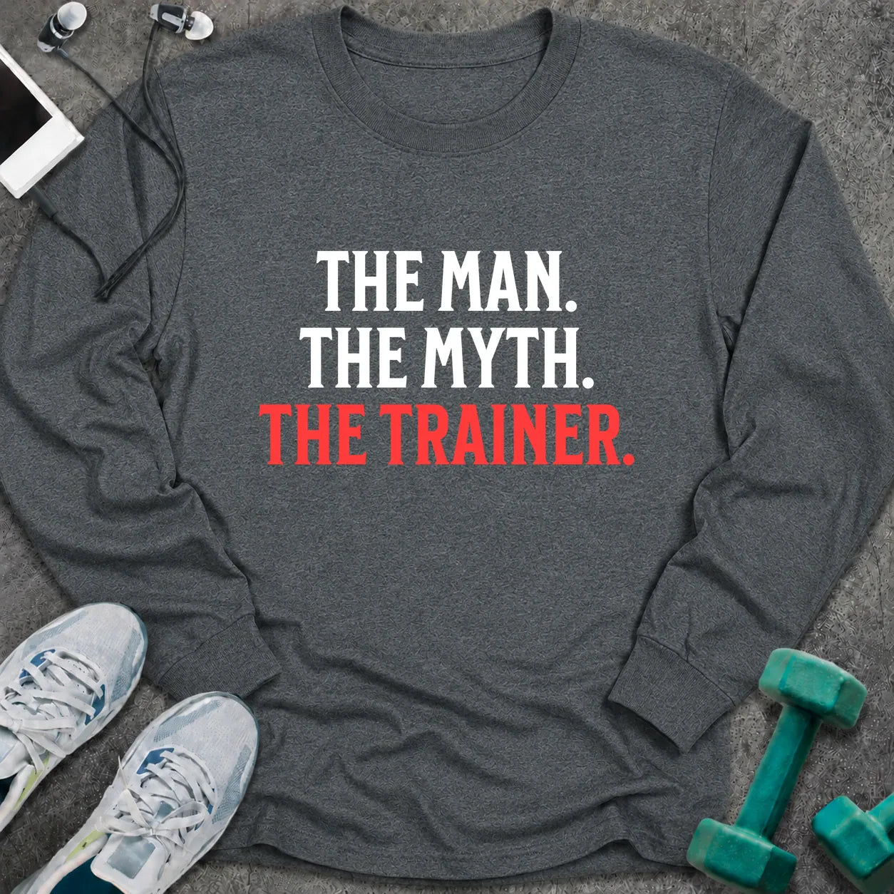 Dark heather long sleeve tee printed with "The Man. The Myth. The Trainer." in white and coral