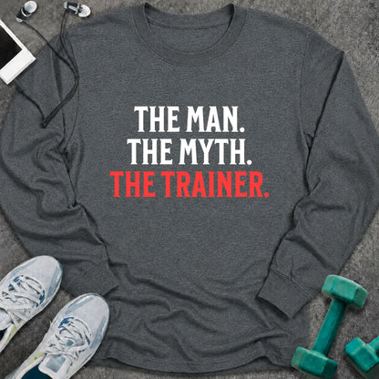 Dark heather long sleeve tee printed with "The Man. The Myth. The Trainer." in white and coral