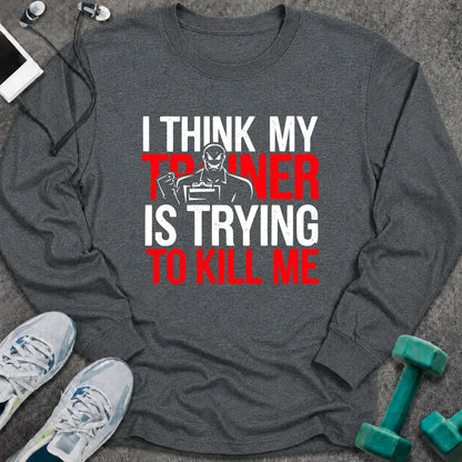 Dark heather long sleeve tee printed with "I Think My Trainer Is Trying To Kill Me" in white and red, with a trainer figure behind the lettering