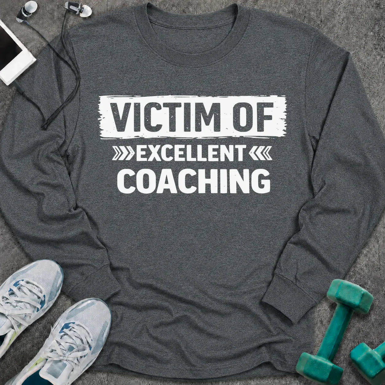 Dark heather long sleeve tee printed with "Victim Of Excellent Coaching" in white, with a painted brush stroke banner