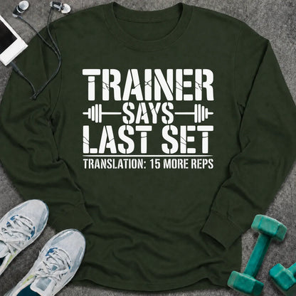 Forest green long sleeve tee printed with "Trainer Says Last Set. Translation: 15 More Reps" in white, with barbell accents