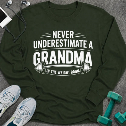 Forest green long sleeve tee printed with "Never Underestimate A Grandma In The Weight Room" in white, with a barbell