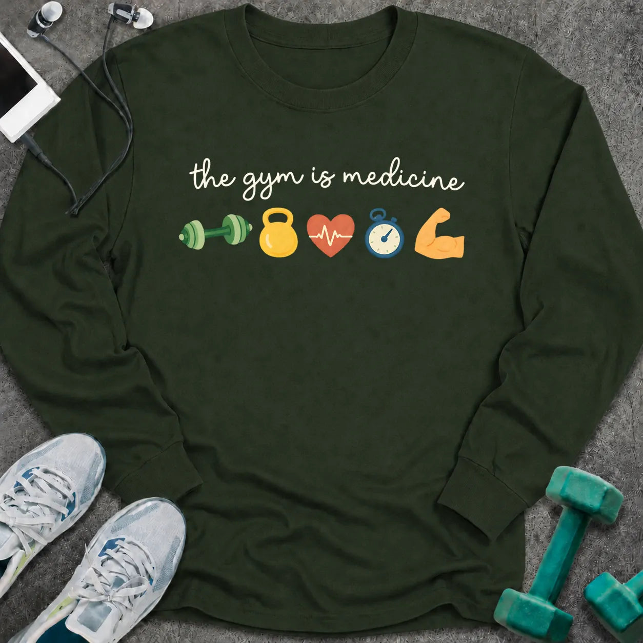 Forest green long sleeve tee printed with "the gym is medicine" in white script, with dumbbell, kettlebell, heart, stopwatch and flexed arm icons