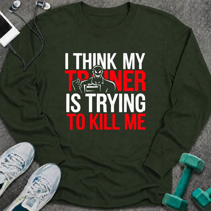 Forest green long sleeve tee printed with "I Think My Trainer Is Trying To Kill Me" in white and red, with a trainer figure behind the lettering
