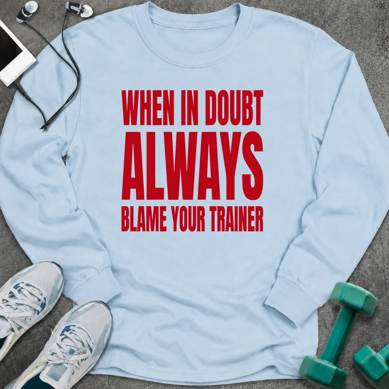 Light blue long sleeve tee printed with "When In Doubt Always Blame Your Trainer" in red