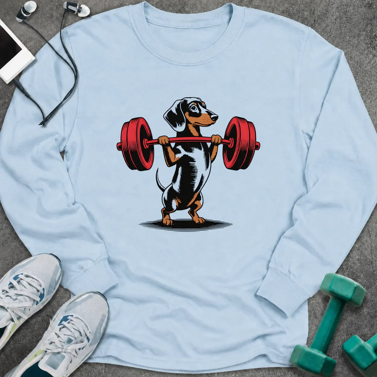Light blue long sleeve tee printed with a dachshund pressing a red barbell overhead