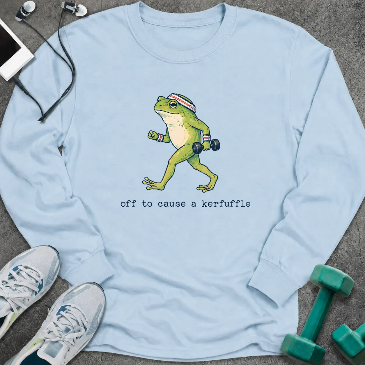 Light blue long sleeve tee printed with "off to cause a kerfuffle" in black, with a green frog carrying dumbbells