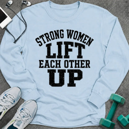 Light blue long sleeve tee printed with "Strong Women Lift Each Other Up" in black distressed varsity lettering