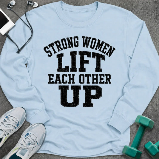 Light blue long sleeve tee printed with "Strong Women Lift Each Other Up" in black distressed varsity lettering