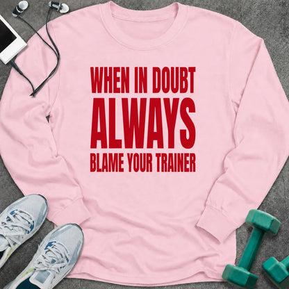 Light pink long sleeve tee printed with "When In Doubt Always Blame Your Trainer" in red