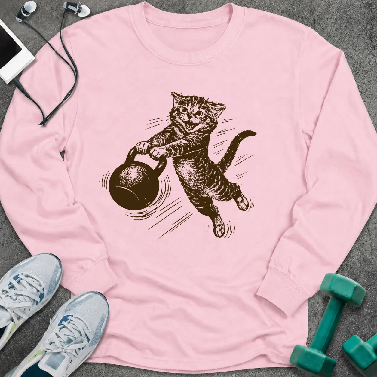 Light pink long sleeve tee printed with a sepia sketch of a cat swinging a kettlebell