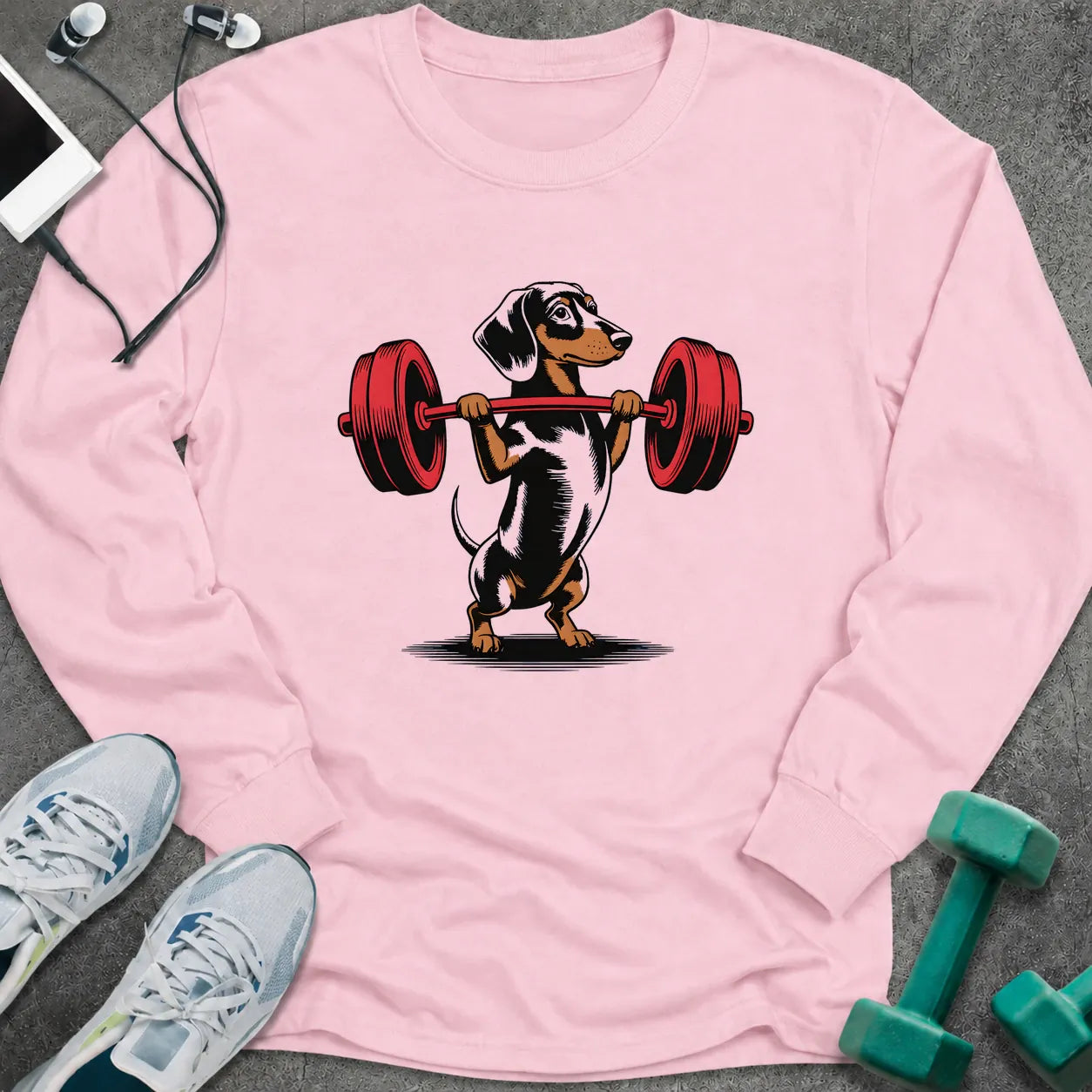 Light pink long sleeve tee printed with a dachshund pressing a red barbell overhead