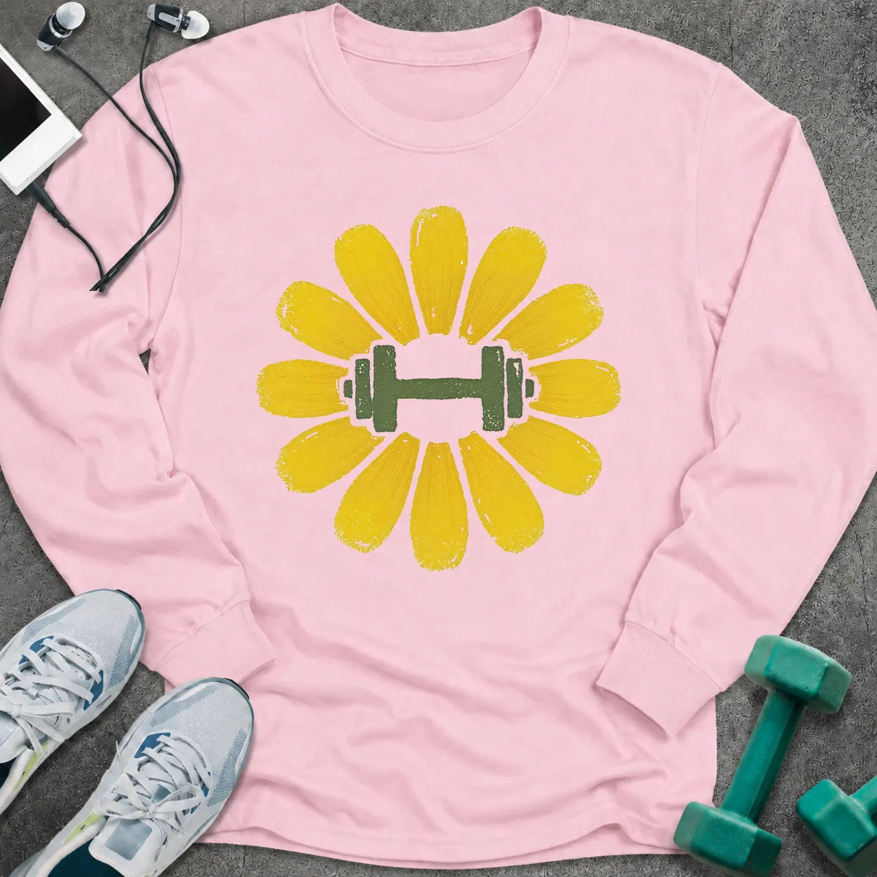 Light pink long sleeve tee printed with a yellow flower with a green dumbbell at its center