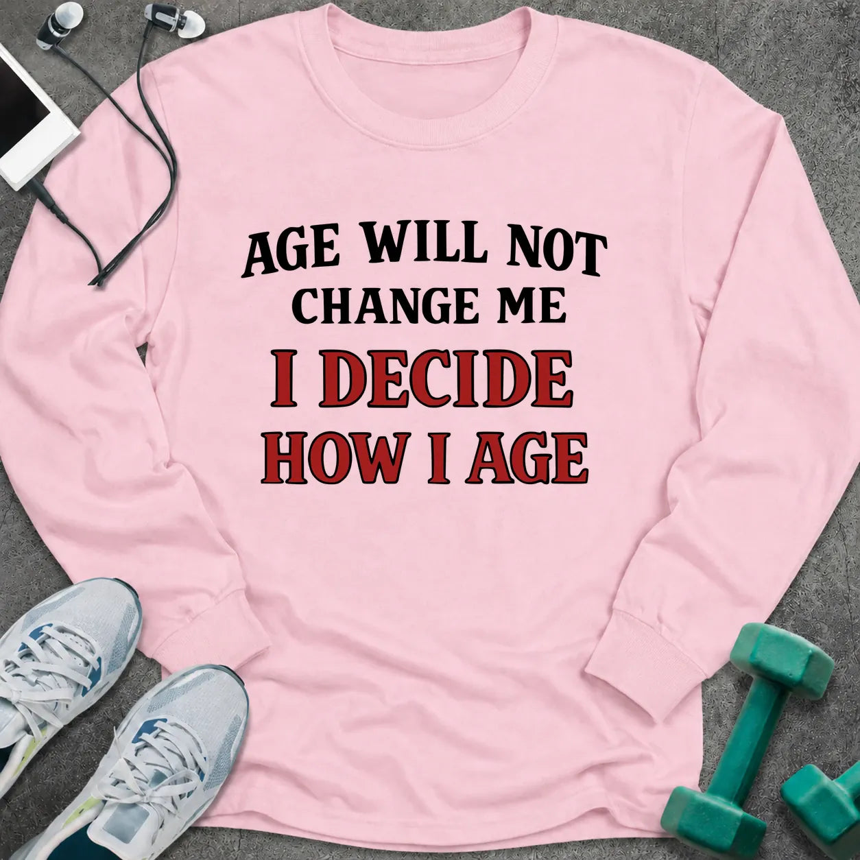 Light pink long sleeve tee printed with "Age Will Not Change Me, I Decide How I Age" in black and red