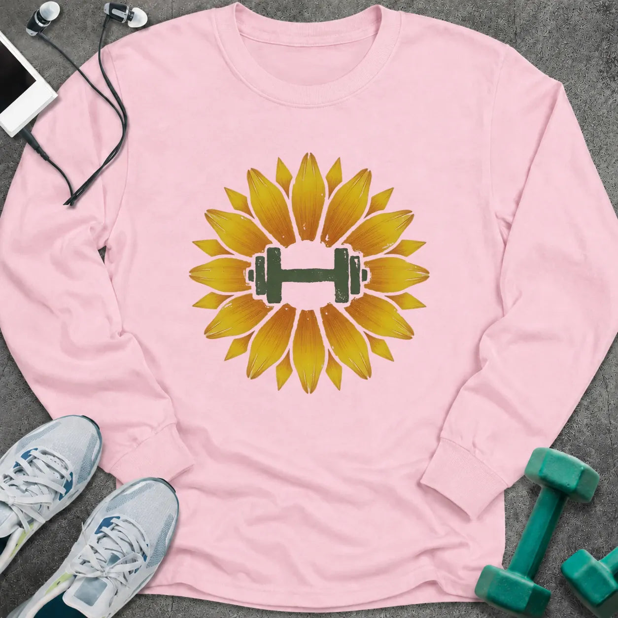 Light pink long sleeve tee printed with a sunflower with a green dumbbell at its center