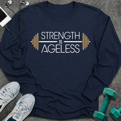 Navy long sleeve tee printed with "Strength is Ageless" in white and gold, with a barbell framing the words