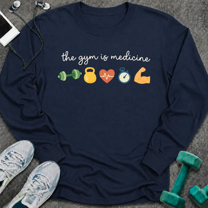 Navy long sleeve tee printed with "the gym is medicine" in white script, with dumbbell, kettlebell, heart, stopwatch and flexed arm icons