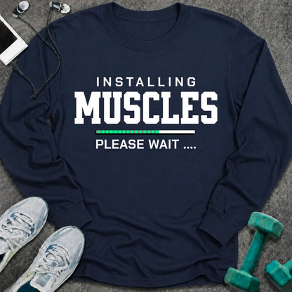Navy long sleeve tee printed with "Installing Muscles Please Wait" in white, with a green loading bar