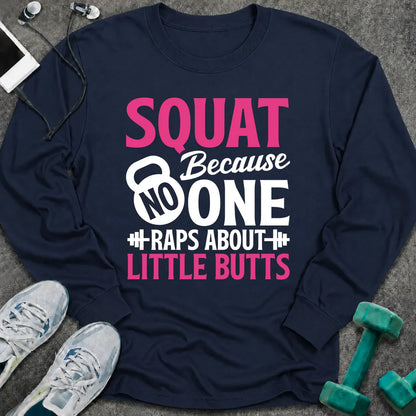 Navy long sleeve tee printed with "Squat Because No One Raps About Little Butts" in pink and white, with a kettlebell and dumbbells worked into the lettering