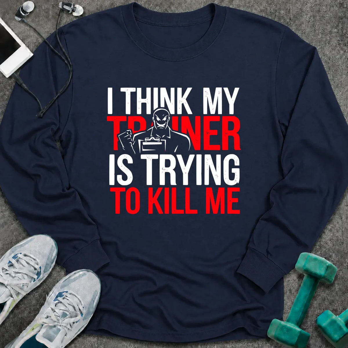Navy long sleeve tee printed with "I Think My Trainer Is Trying To Kill Me" in white and red, with a trainer figure behind the lettering