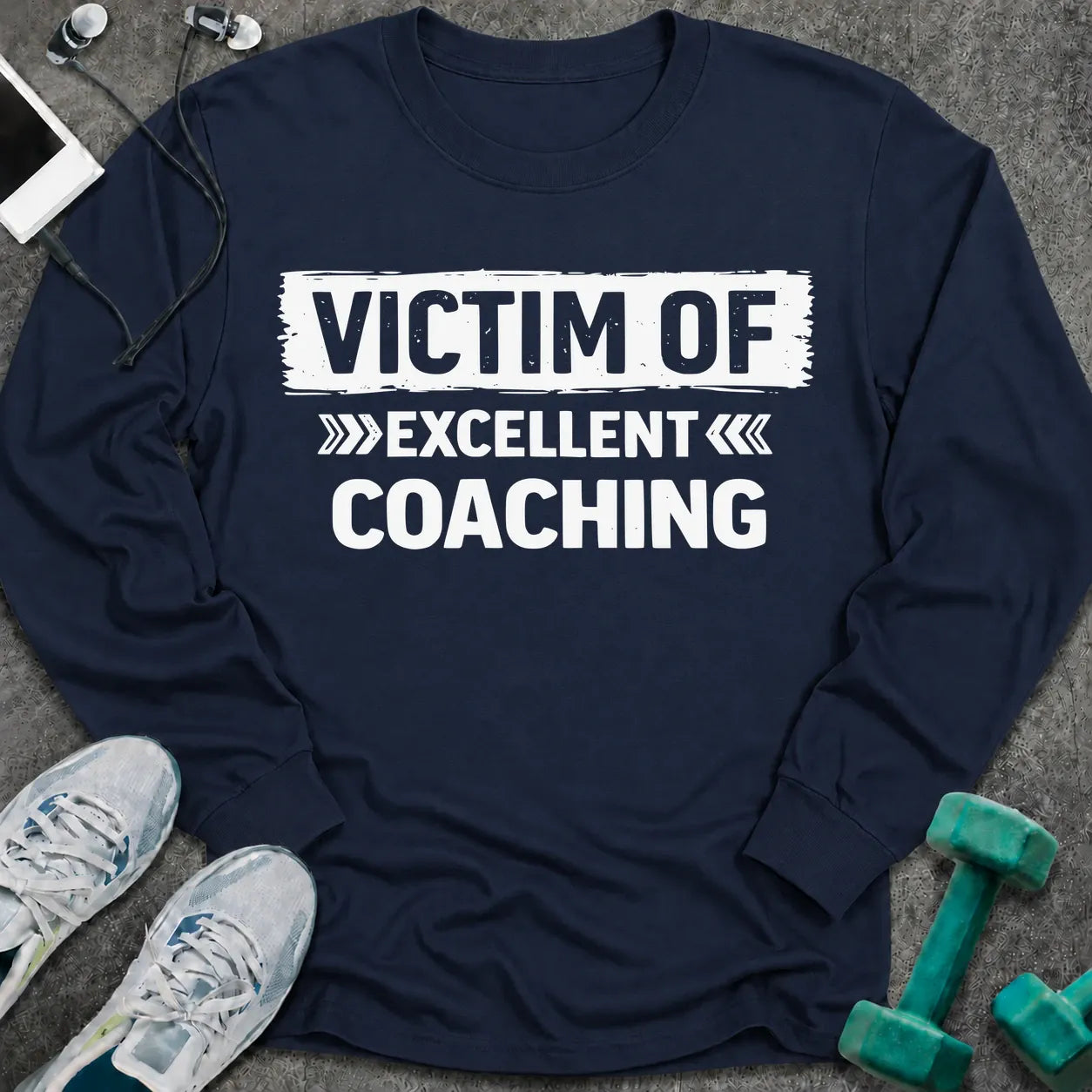 Navy long sleeve tee printed with "Victim Of Excellent Coaching" in white, with a painted brush stroke banner