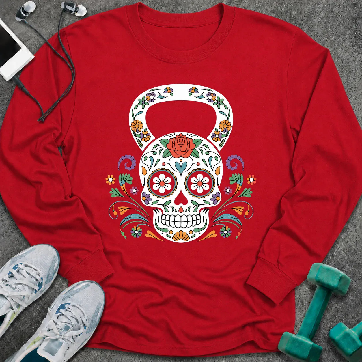 Red long sleeve tee printed with a sugar skull kettlebell covered in colorful flowers
