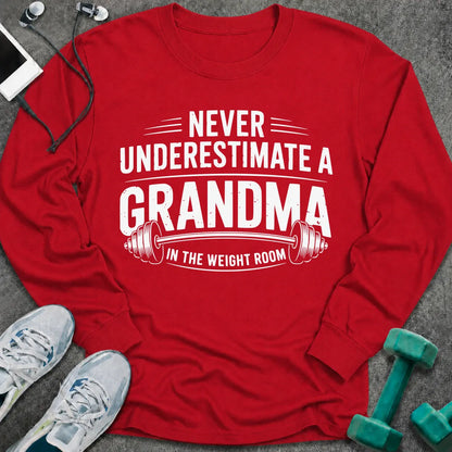 Red long sleeve tee printed with "Never Underestimate A Grandma In The Weight Room" in white, with a barbell