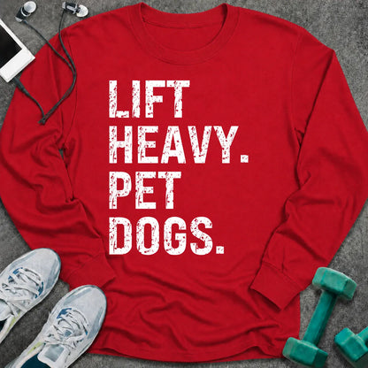 Red long sleeve tee printed with "Lift Heavy. Pet Dogs." in white distressed lettering