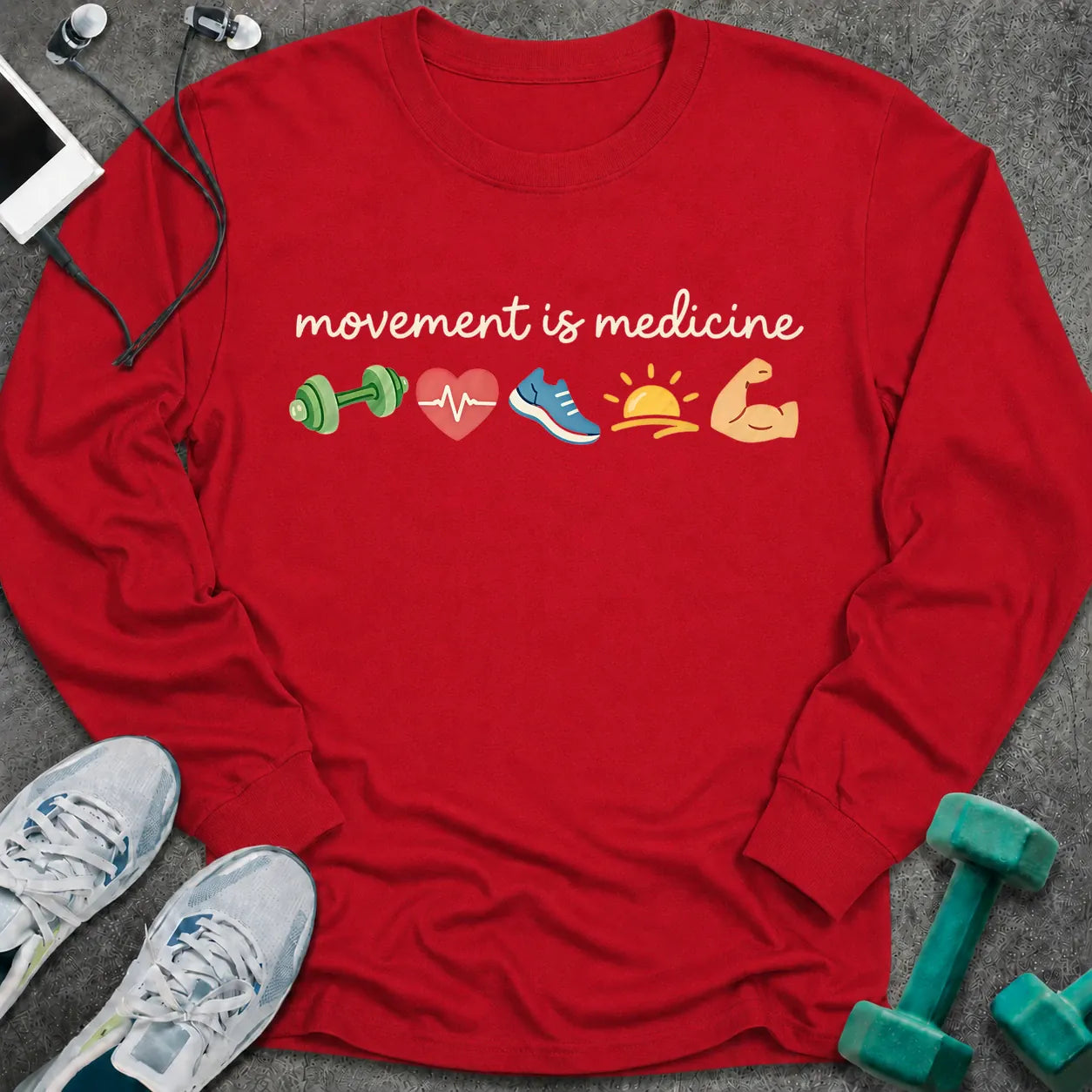 Red long sleeve tee printed with "movement is medicine" in white script, with dumbbell, heart, running shoe, sunrise and flexed arm icons